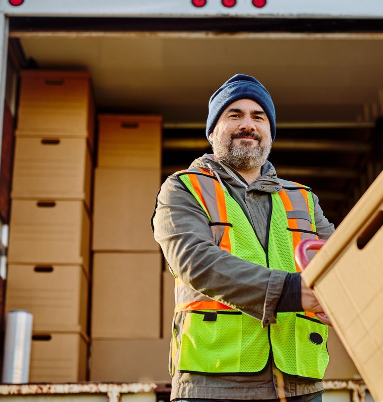 US AMG Proftrans worker-loading-packages-into-a-truck
